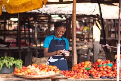 A happy seller counting her cash